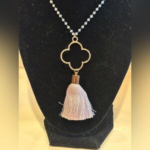 Jane Marie necklace tassel with gold toned clover on faceted bead necklace.